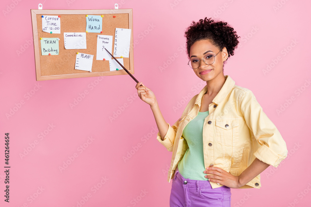 Photo of smart millennial brunette lady point board wear yellow shirt eyewear isolated on pink color background Photo of smart millennial brunette lady point board wear yellow shirt eyewear isolated on pink color background