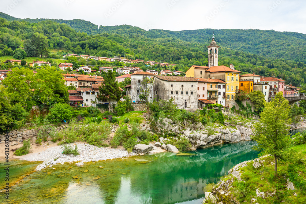 Beautiful, colorful, picturesque small town of Kanal, Slovenia with the clear turquoise Soca River carving the white rocks.