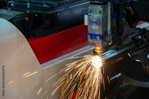 The fiber laser cutting machine cutting the stainless steel tube control by CNC program.