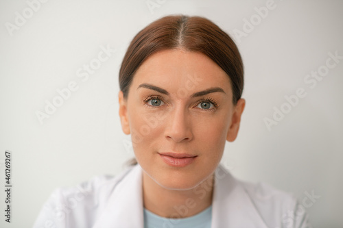 Pretty woman in a white robe on a white baxkground photo