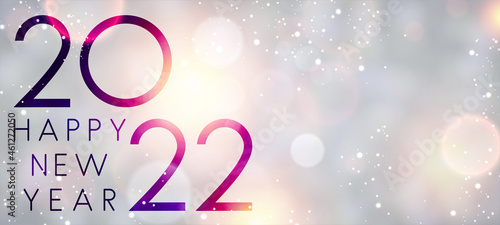 Fogged glass 2022 sign on colorful bokeh background.