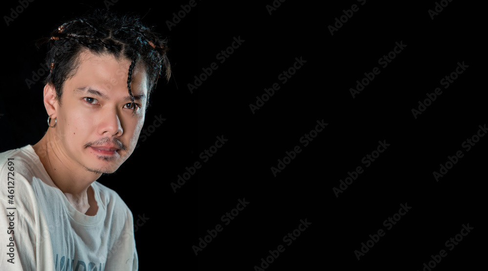 Close-up of young asian man standing on dark background, lovely model . Close-up of young asian man standing on dark background, lovely model .