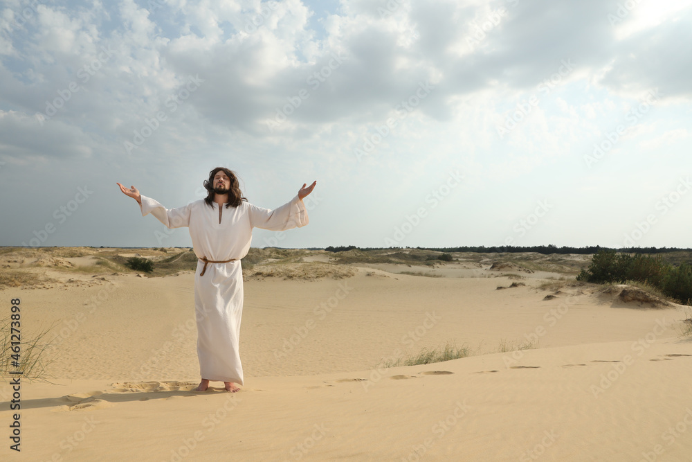 Jesus Christ raising hands in desert. Space for text Jesus Christ raising hands in desert. Space for text
