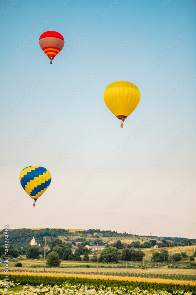 Obraz premium view of air balloon with basket flies on sunset