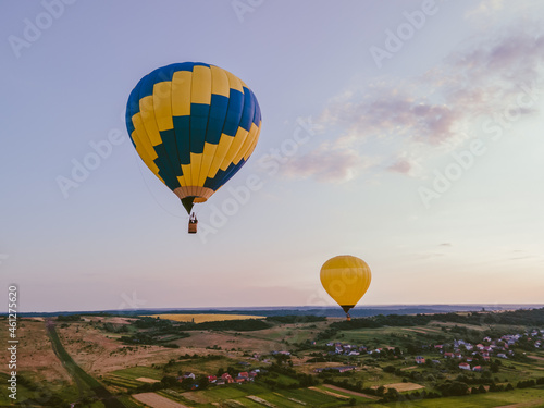 view of air balloon with basket flies on sunset