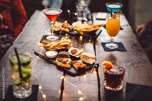 Fotobehang Blurred background of multicolored drinks and minimal food - Happy hour concept