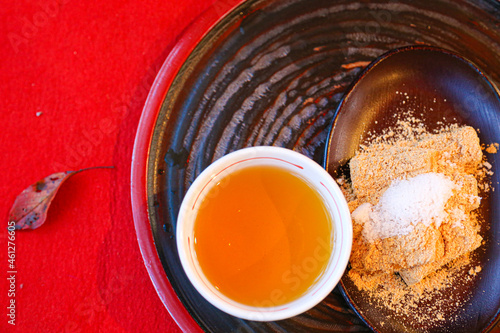 A cup of tea and mochi sprinkled with sweetened soy flour
