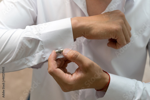 Bilde på lerret A beautiful metal cufflink on a businessman's white men's shirt.