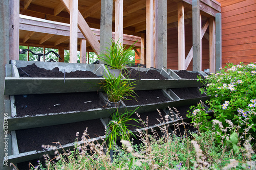 The making of a vertical green wall garden from recycled waste plastics, with substrate and an irrigation system with valves photo