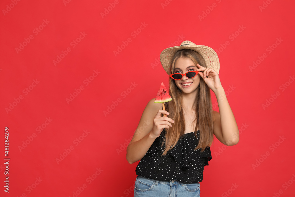 Beautiful girl with piece of watermelon on red background. Space for text Beautiful girl with piece of watermelon on red background. Space for text
