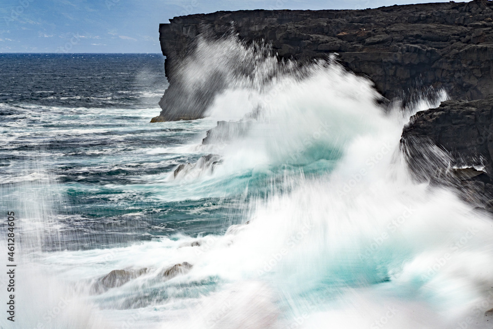 sea in tempest breaking waves on lava rock cliff - obrazy, fototapety, plakaty 