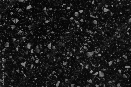 black quartz surface for bathroom or kitchen countertop. close up artificial stone showing stone pigments, crystal, sand, mineral texture and pattern. counter top texture, granite imitation texture.