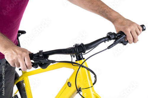 Unrecognizable male hands holding the handlebars of a bicycle, isolated on a white background, close-up view.