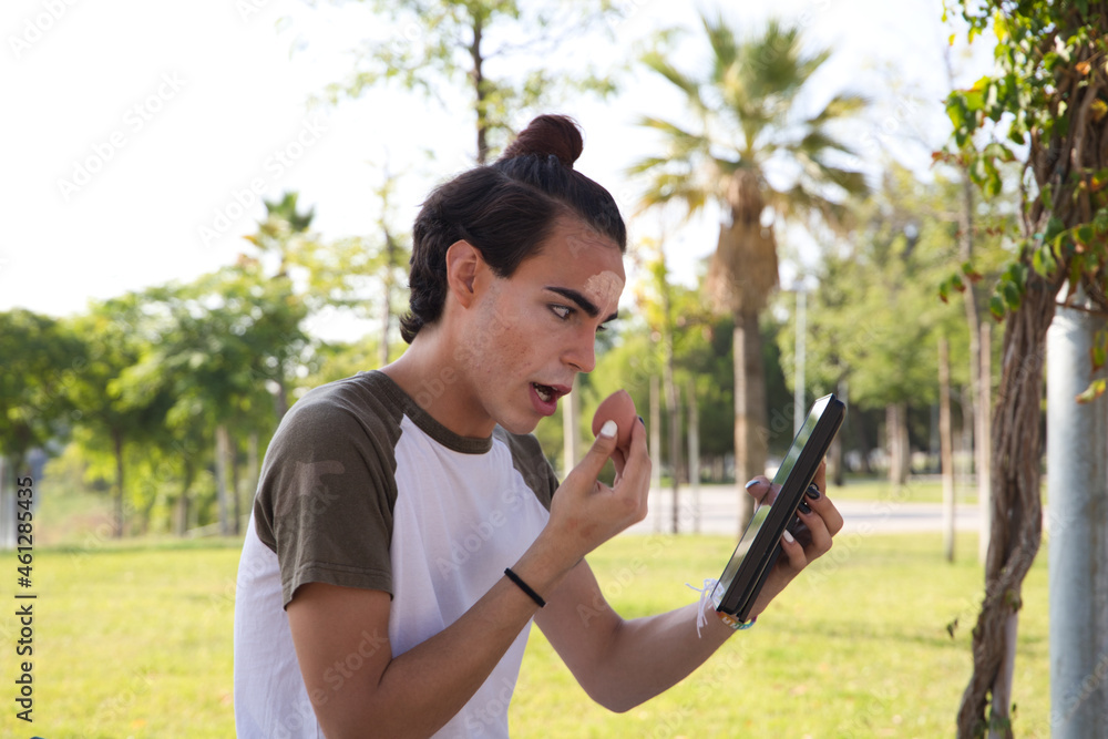 young latina transsexual woman is in a park where she is going to start doing her make-up for her big change from boy to girl. Concept of diversity, transgender, and freedom of homosexual expression. young latina transsexual woman is in a park where she is going to start doing her make-up for her big change from boy to girl. Concept of diversity, transgender, and freedom of homosexual expression.