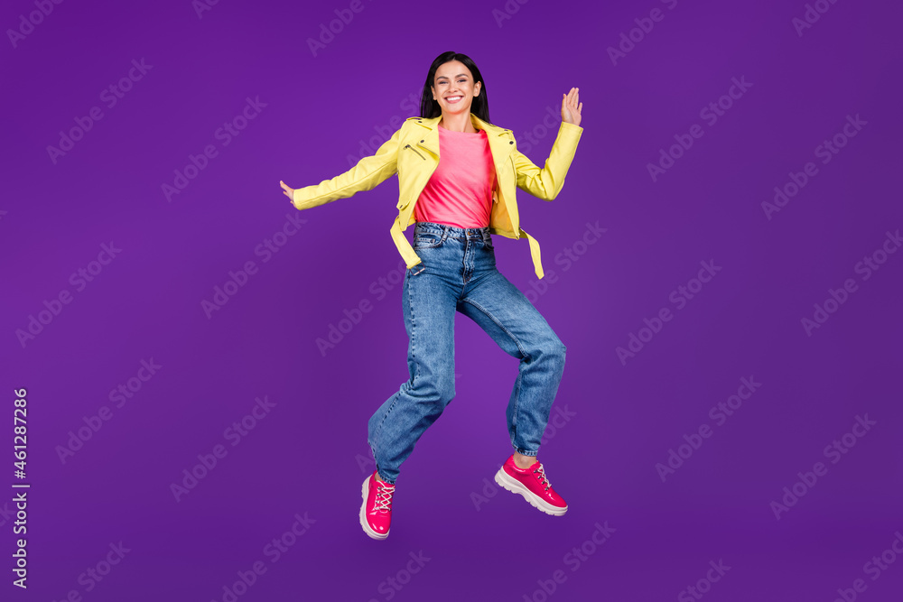 Full size photo of young excited girl jump up energetic youngster stylish outfit autumn isolated over violet color background Full size photo of young excited girl jump up energetic youngster stylish outfit autumn isolated over violet color background