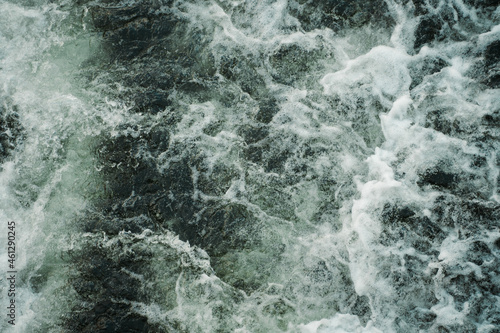 Dark water swirling waves and foam texture background