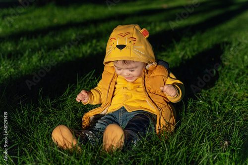 Happy laughing baby boy in sunset lights outdoor in autumn park. The concept of childhood, family and kid.