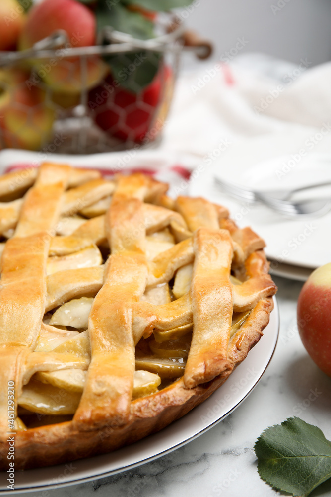 Delicious traditional apple pie on white marble table, closeup