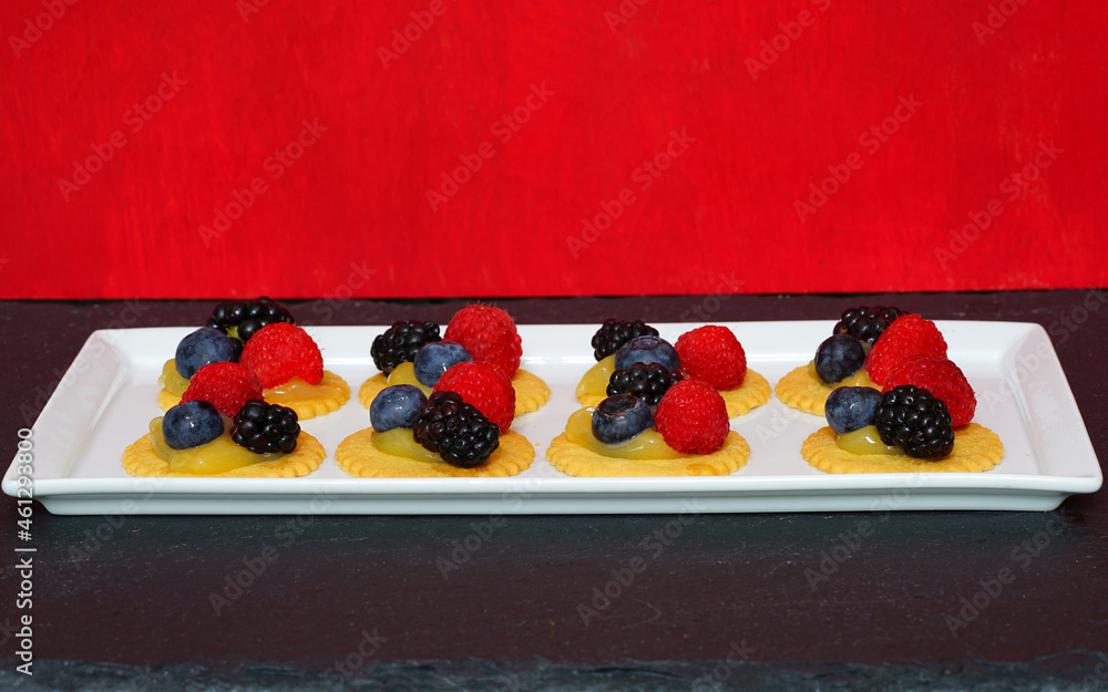 Thin mini lemon tartlets with fresh berries