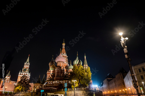 night landscape of the city with illuminated old houses  churches and a fortress wall 