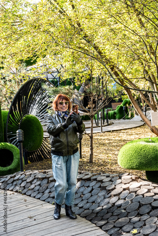 Fototapeta premium woman in children's amusement park on Sunday afternoon in early autumn 