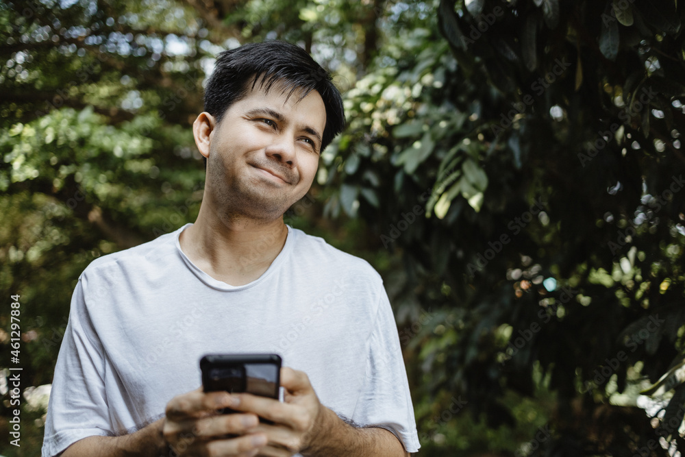 Portrait asian man happy smile holding smartphone in hand