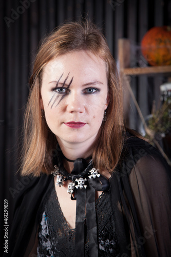 Portrait of young beautiful witch at Halloween 