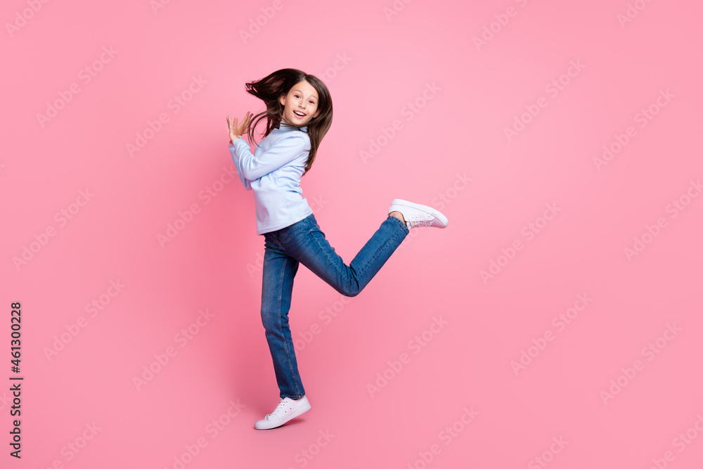 Full length body size view of pretty cheerful funny girl jumping having fun good mood isolated over pink pastel color background Full length body size view of pretty cheerful funny girl jumping having fun good mood isolated over pink pastel color background