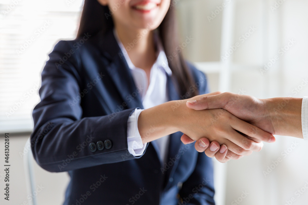 Obraz premium Business woman greeting with shake hands to congratulate after agreement with partner. Two business partners greeting together