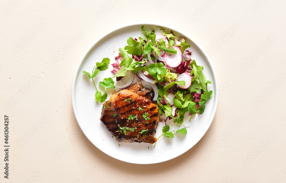 Roasted pork steak with salad from fresh vegetable Roasted pork steak with salad from fresh vegetable