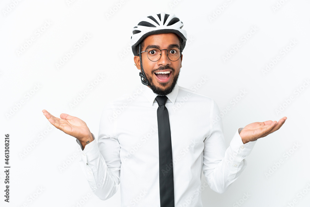 Young business latin man holding a bike helmet isolated on white background with shocked facial expression Young business latin man holding a bike helmet isolated on white background with shocked facial expression