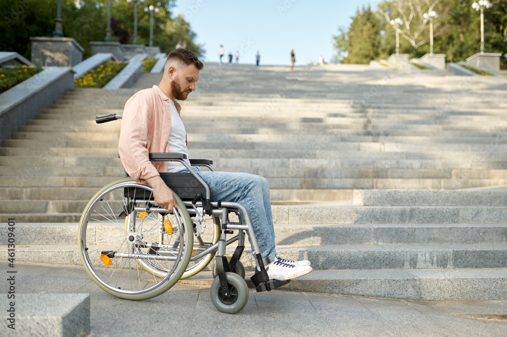 Alone man in wheelchair at the stairs, disability Alone man in wheelchair at the stairs, disability