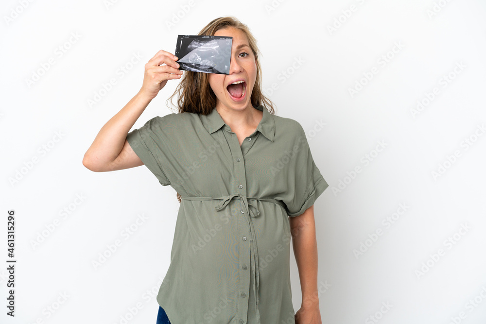 Young caucasian woman isolated on white background pregnant and holding an ultrasound Young caucasian woman isolated on white background pregnant and holding an ultrasound