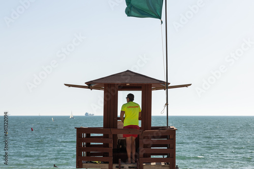 Lifeguard observing sea on beach watchtower