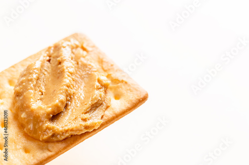 Peanut butter spread on soda crackers close up