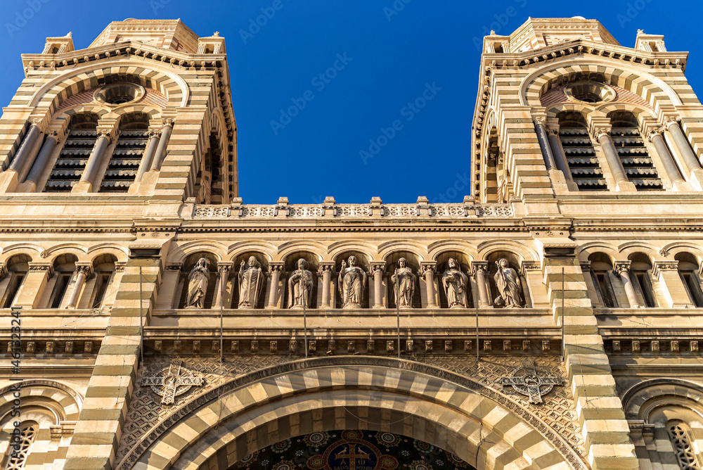Detail of the front facade with an arch two towers and saints sculptures of the Cathedrale La Major in Marseilles