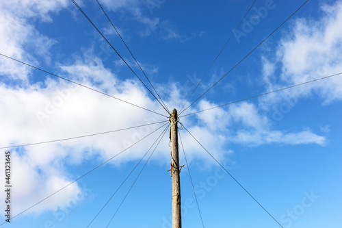 A telegraph pole carrying telephone cables to suburban houses in a town in the UK