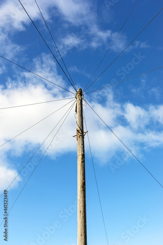 A telegraph pole carrying telephone cables to suburban houses in a town in the UK