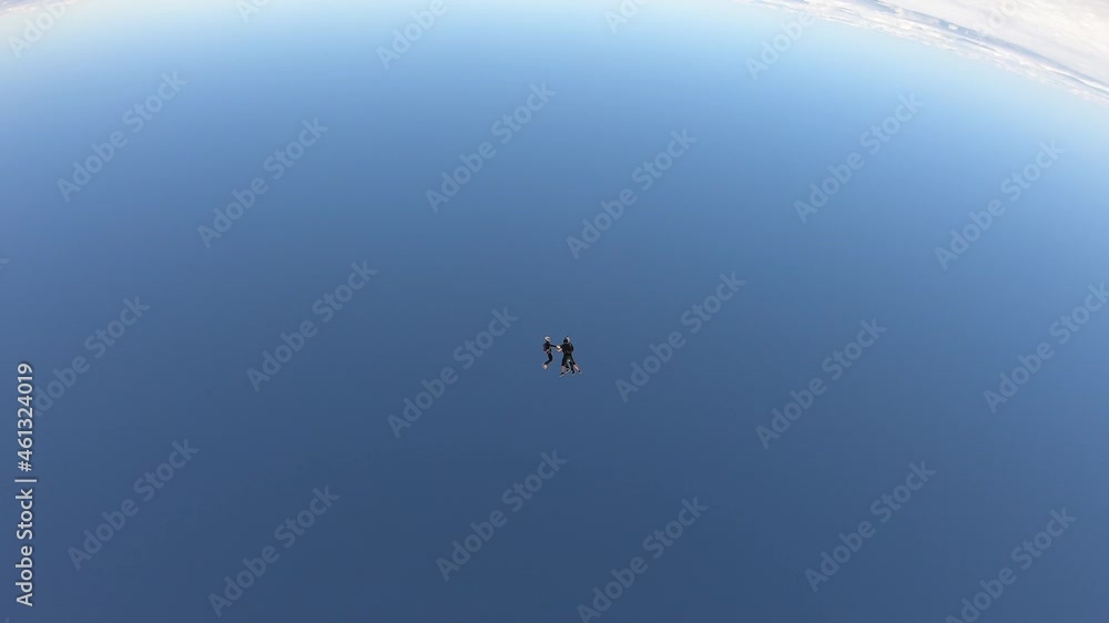 Skydiving. Freefly jump. Three skydivers are falling in the sky. Skydiving. Freefly jump. Three skydivers are falling in the sky.
