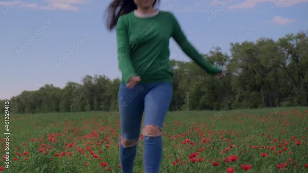 Asian woman running on green field with poppies Asian woman running on green field with poppies