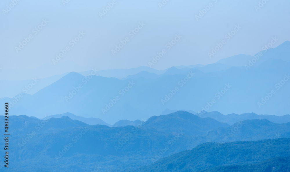 Blue mountain range silhouette with morning haze