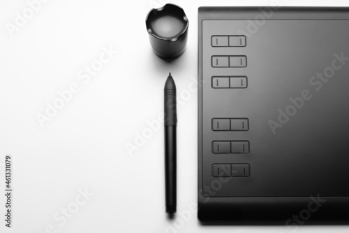 Graphic tablet with pen for illustrators and designers on white background. Copy space.