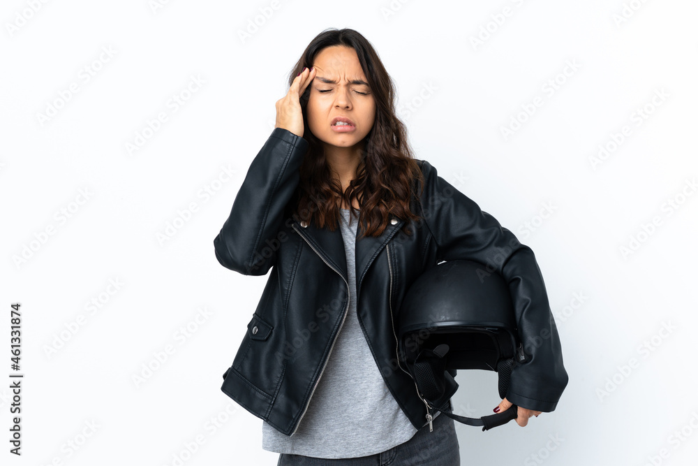 Young woman holding a motorcycle helmet over isolated white background with headache Young woman holding a motorcycle helmet over isolated white background with headache