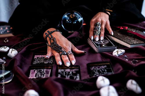 caucasian witch reading magic tarot card and divination crystall ball