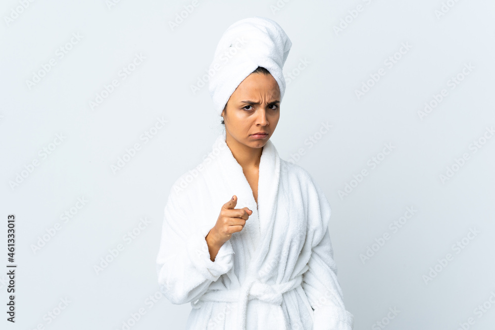 Young woman in bathrobe over isolated white background frustrated and pointing to the front Young woman in bathrobe over isolated white background frustrated and pointing to the front