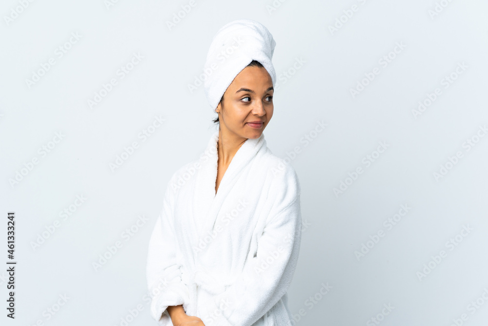 Young woman in bathrobe over isolated white background . Portrait Young woman in bathrobe over isolated white background . Portrait