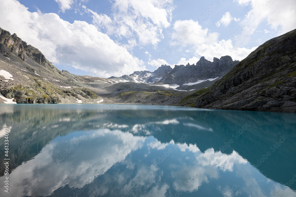 Obraz premium Amazing hiking day in one of the most beautiful area in Switzerland called Pizol in the canton of Saint Gallen. A wonderful view at the alpine lake called Wildsee with a tent by the lake. Epic view.
