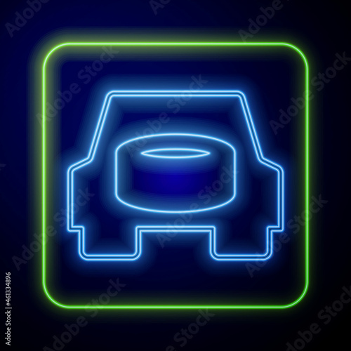 Glowing neon Spare wheel in the car icon isolated on blue background. Process of replacing the wheel. Storage location of the spare wheel in the trunk. Vector