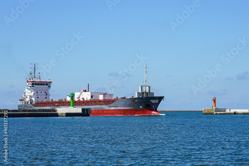 the cement transport vessel enters the port through the breakwater gate