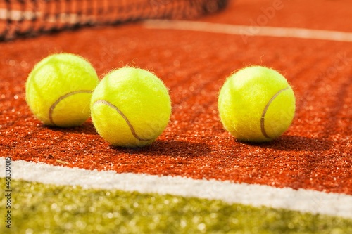Tennis balls on a red clay court © BillionPhotos.com
